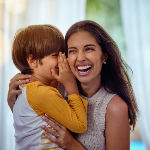 Hey mom guess what I love you. Shot of an adorable little boy whispering into his mothers ear